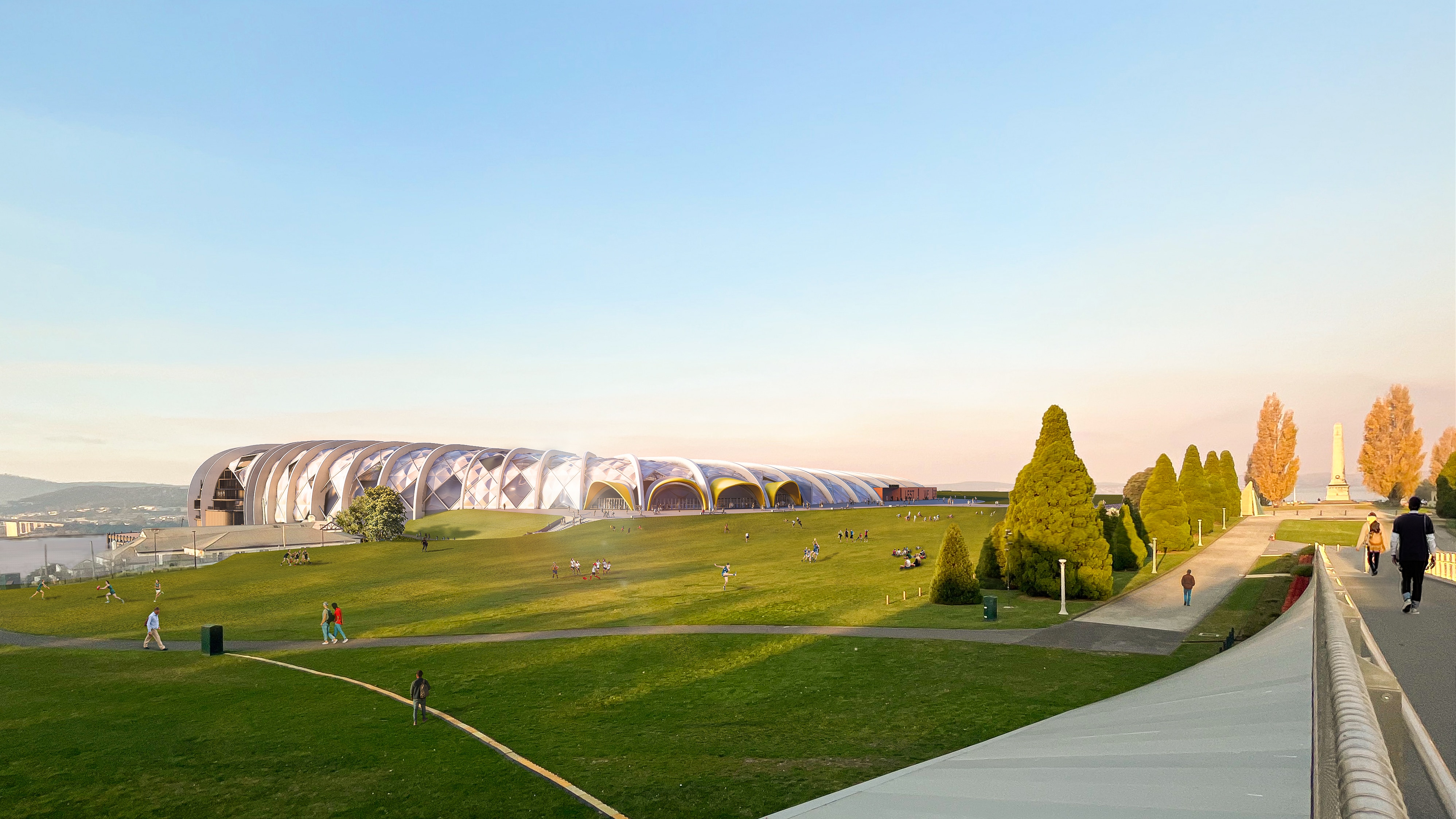 A silver wedge-shaped building juts out of a hill. 