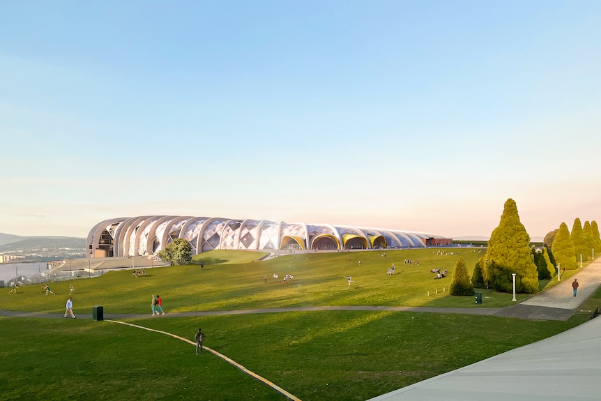 A silver wedge-shaped building juts out of a hill. 