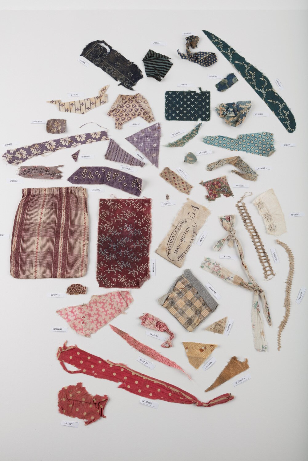 A flat-lay of scraps of fabric from the 1800s
