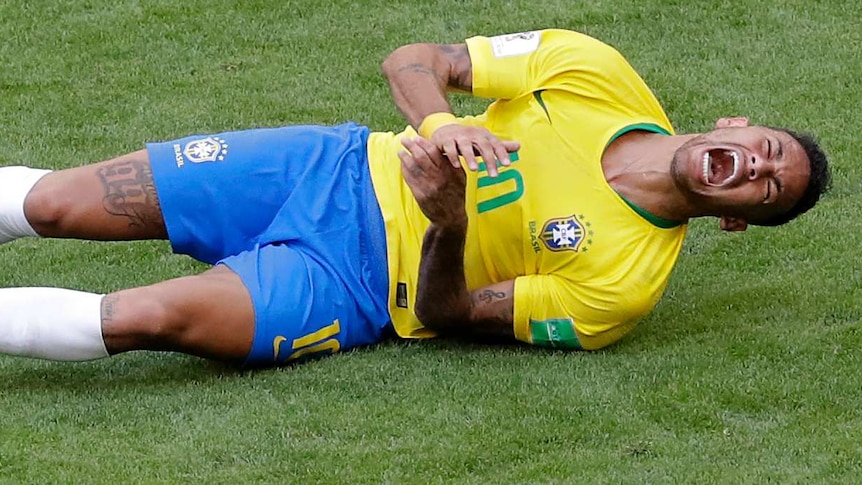 Neymar rolls on the ground in supposed pain after a tackle.