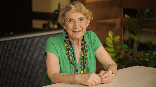 Dr Yvonne McMaster sits at a desk