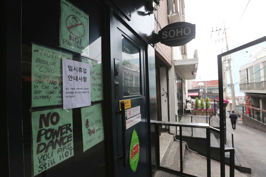 Signs posted on a closed door with messages such as 'NO POWER DANCE - YOU ARE STILL HOT'