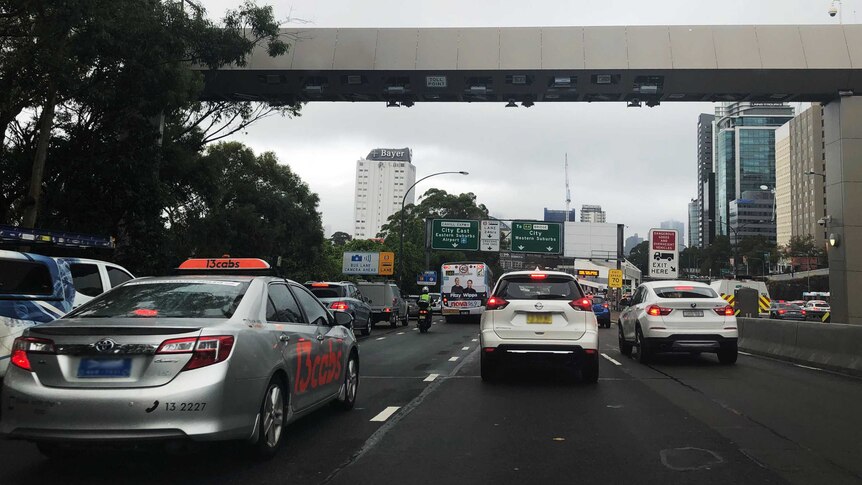 Cars driving beneath the Sydney Harbour Bridge toll point