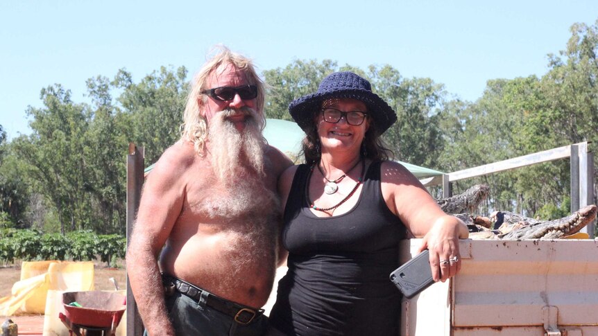 A couple next to a ute.
