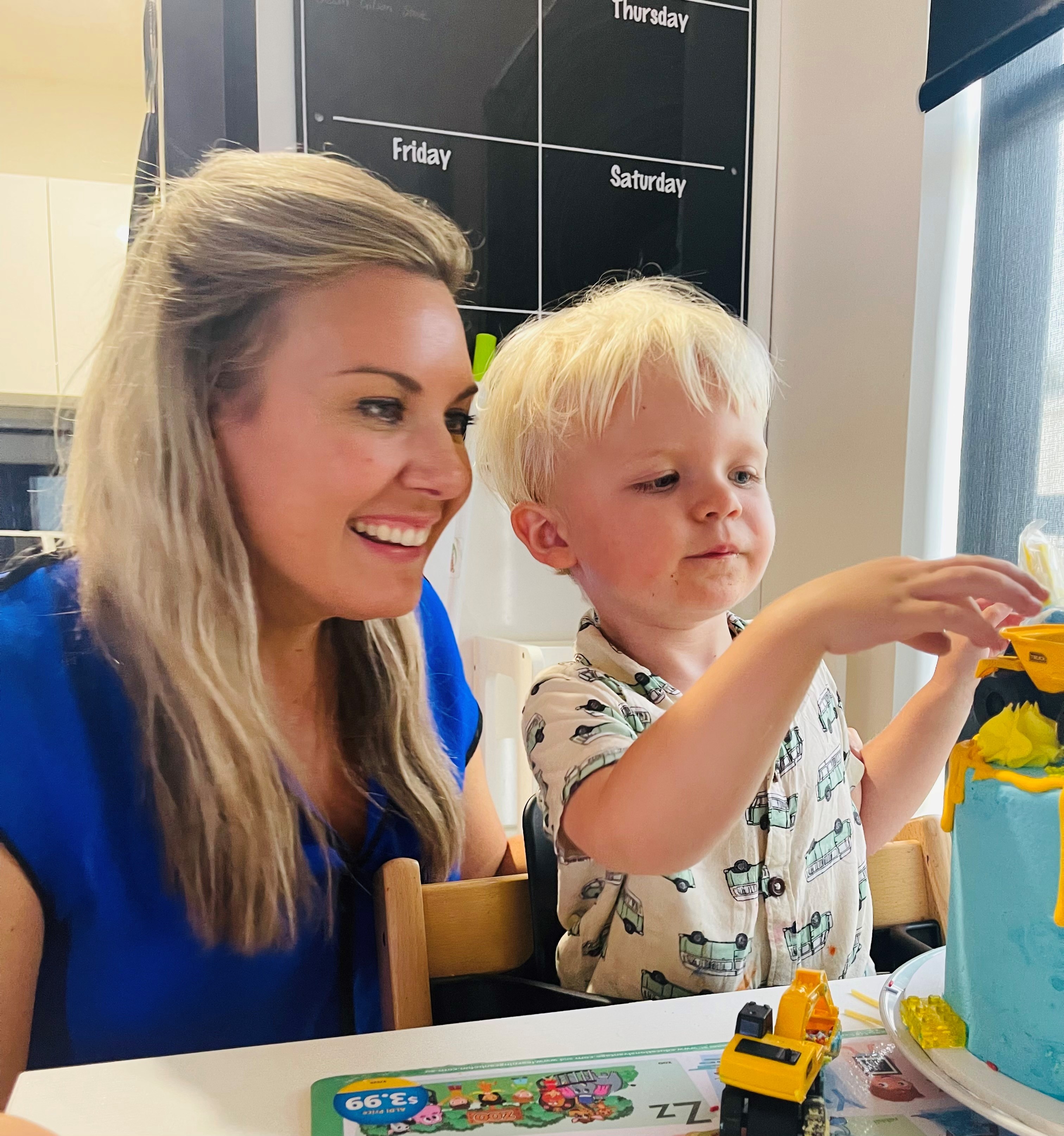 A boy and his mother play at a table.