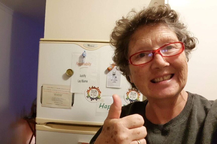 Ms O'Connor takes a selfie in front of her donated fridge.