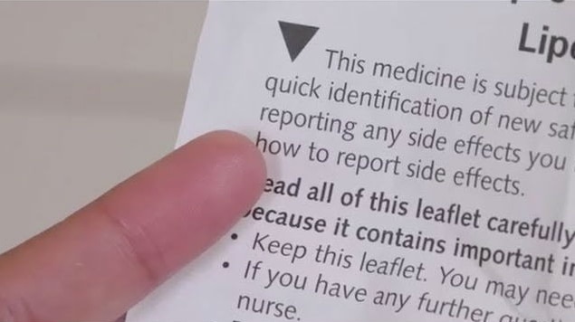A black triangle is printed on a leaflet promoting medicine to alert readers to possible side effects.