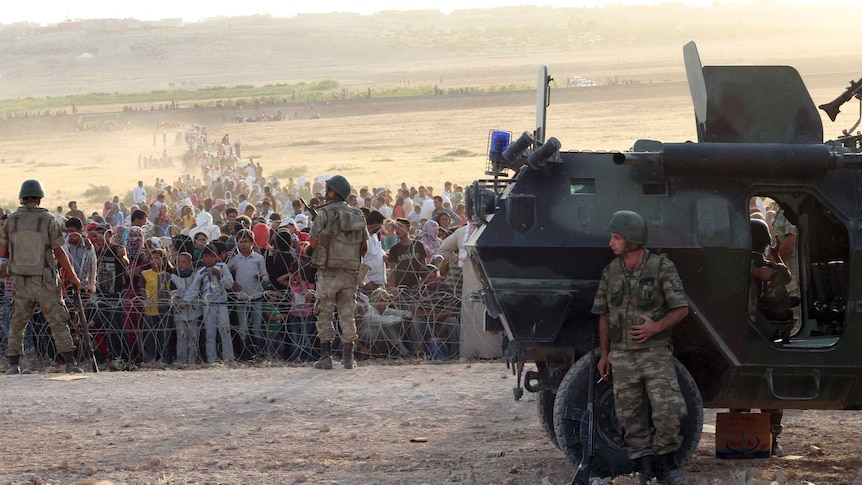 Kurdish civilians flee to the Turkish border