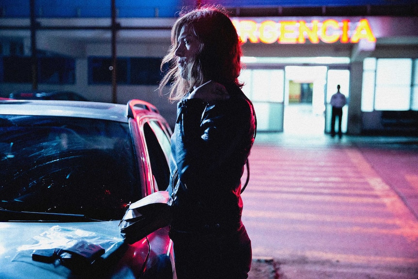 Still image of 2018 film A Fantastic Woman of Daniela Vega standing outside a hospital at night time.