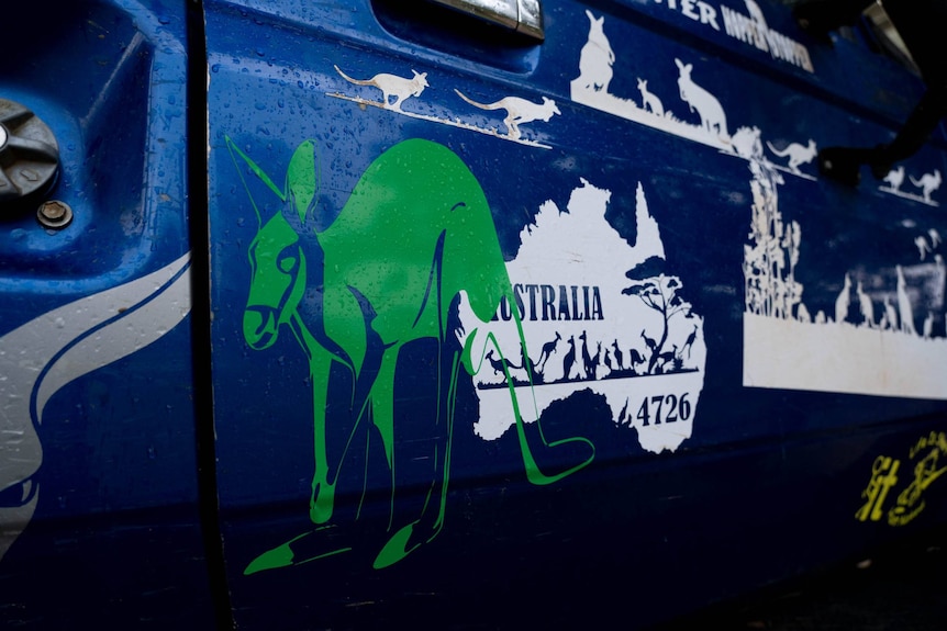 On the side of Dave Coulton's car are images of kangaroos and a map of Australia.