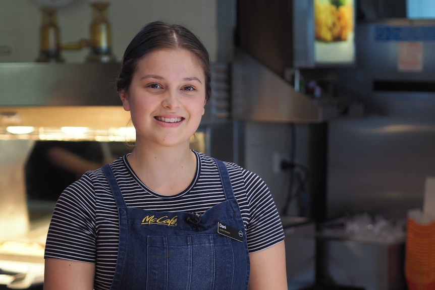 A young woman wearing a McDonald's McCafe uniform