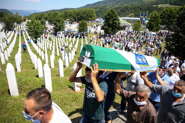 Men carry a coffin at a graveyard during a mass funeral in Potocari near Srebrenica, Bosnia and Herzegovina.