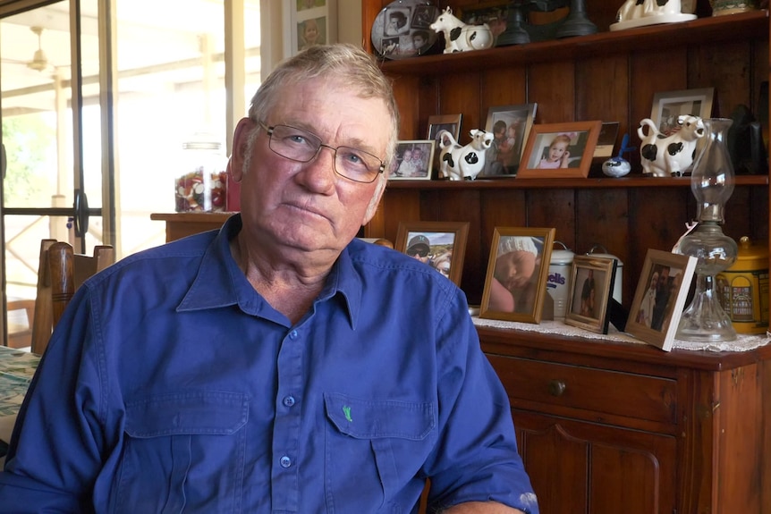 Man wearing a blue shirt, sitting down.