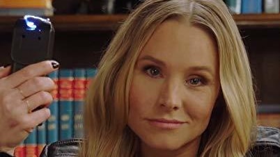 Veronica Mars smirks at the camera while holding a taser.