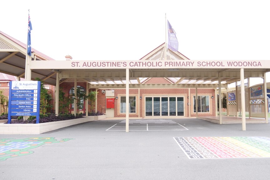 exterior of school building with sign that reads st augustine's primary school