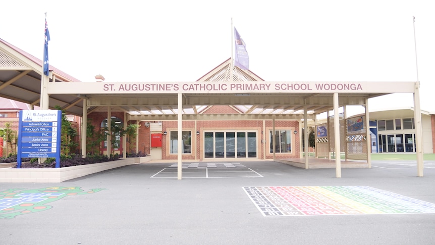 exterior of school building with sign that reads st augustine's primary school