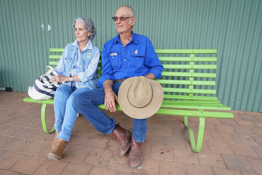 Royelene and Darryl Hill sit on a bench at the Katherine show.