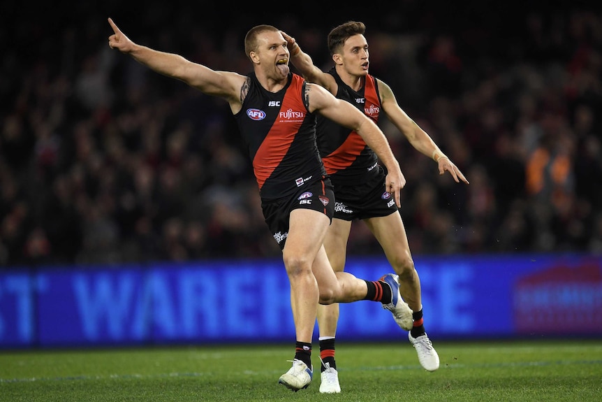 Jake Stringer (L) and Orazio Fantasia of the Bombers react to a Stringer goal against Sydney.