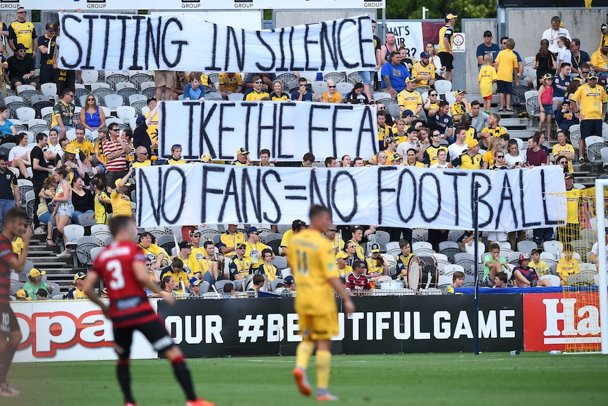 Mariners supporters hold a silent protest at a game between the Central Coast Mariners and Western Sydney Wanderers.