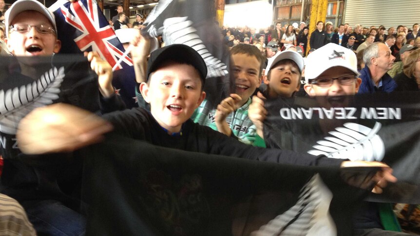 New Zealand fans on Auckland's waterfront watch the America's Cup races.
