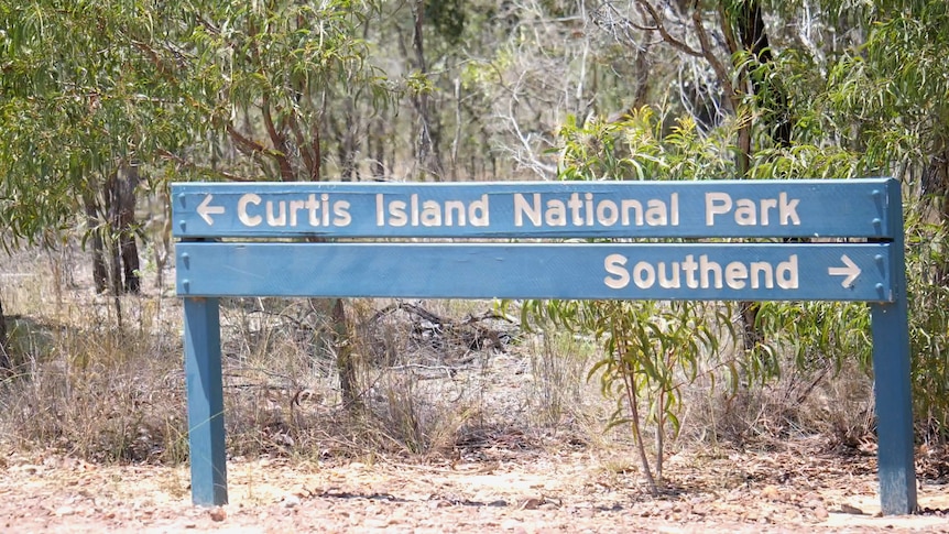 A sign in front of shrubs reads Curtis Island National Park and another reads southend.