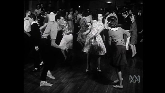 Old photo shows people dancing The Stomp on dancefloor