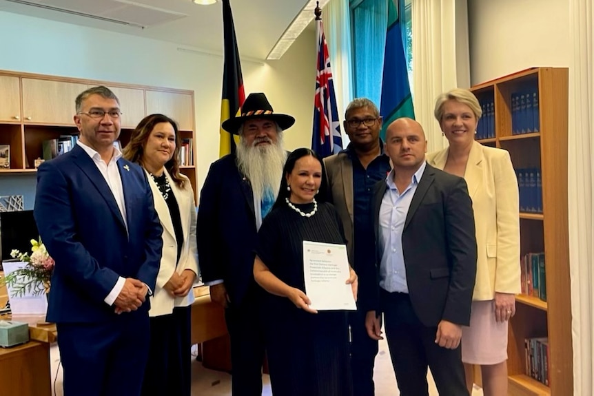 Federal ministers Linda Burney (front, holding document) and Tania Plibersek (right) announced the new protections today.
