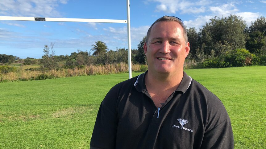 Former North Sydney Bears player Josh Stuart standing in front of a rugby league post on a field