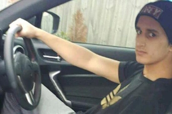 A photo of Numan Haider at the wheel of a car.