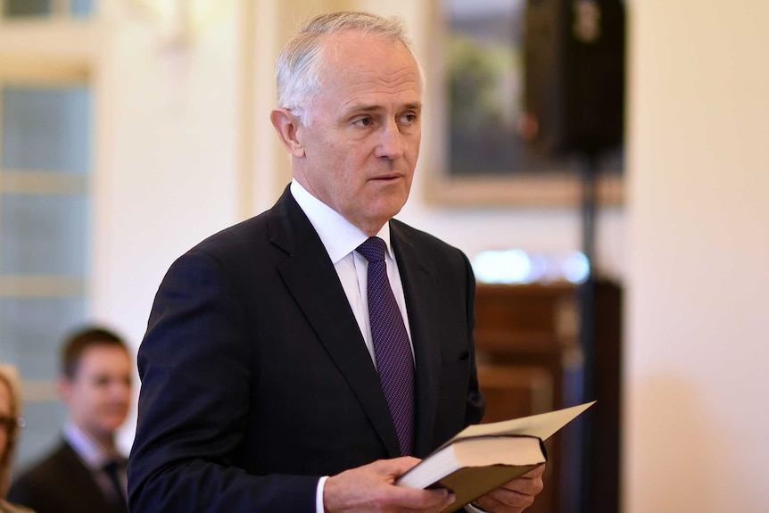 Malcolm Turnbull with bible, being sworn in as PM, Sep 15 2015