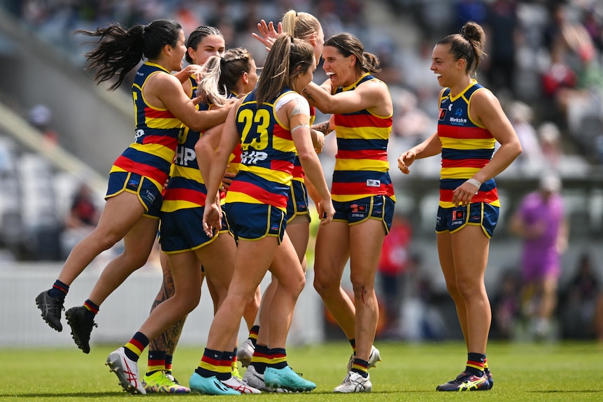 Adelaide Crows AFLw players celebrate a goal against GWS.
