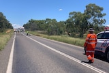 The Flinders Highway with police, trucks, and police cars looking at the scene of an accident