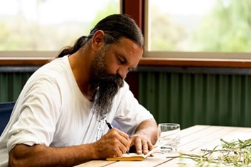 Ngarrindjeri man Leon Dodd recording features of swamp plants.