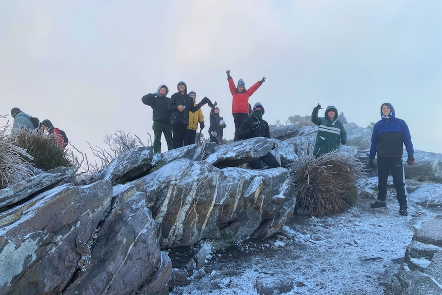 A bunch of hikers in a snowdrift on a hill