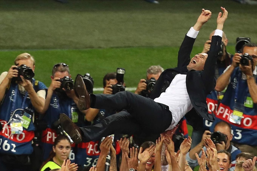 Zinedine Zidane is lifted up by Real Madrid players