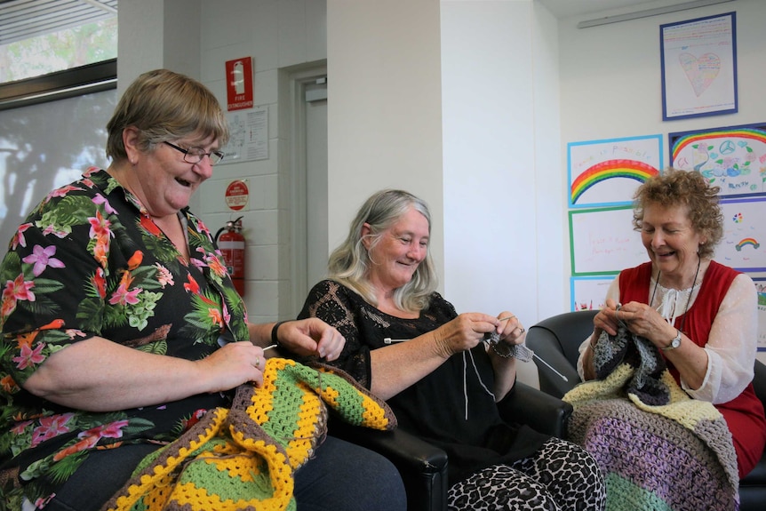 Three women knitting.