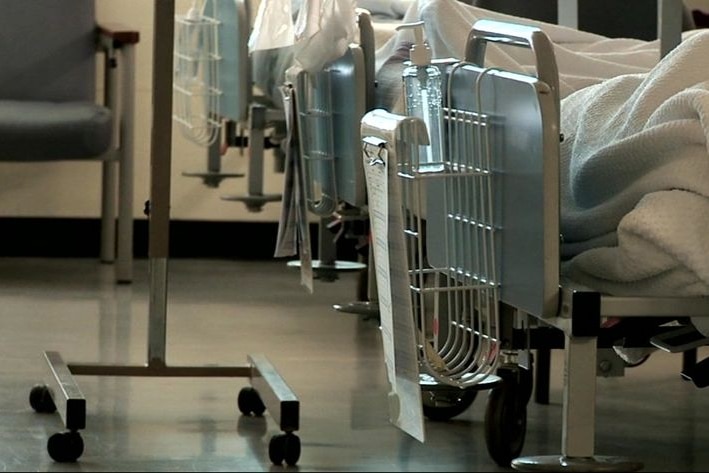 A row of patient beds in a hospital.