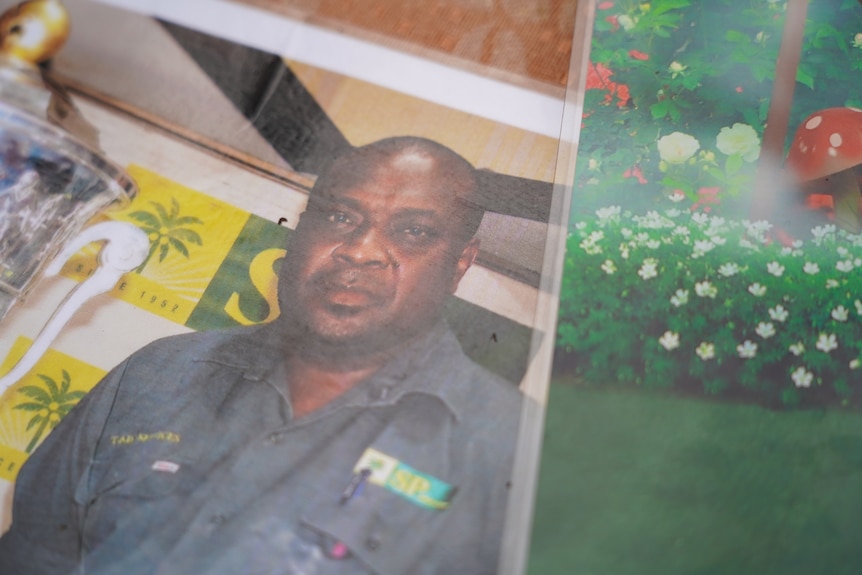 A photo of a Papua New Guinean man in a blue shirt 