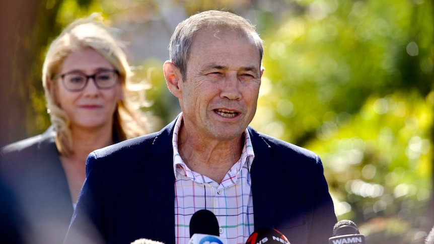 Roger Cook speaking to the media, with deputy Rita Saffioti in the background.