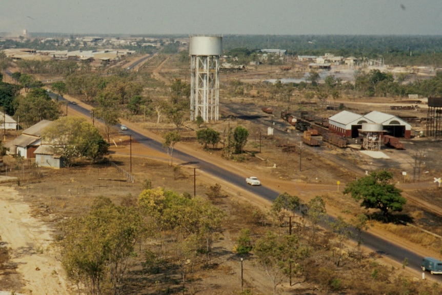 A grainy colour photo of a treeless suburban vista.