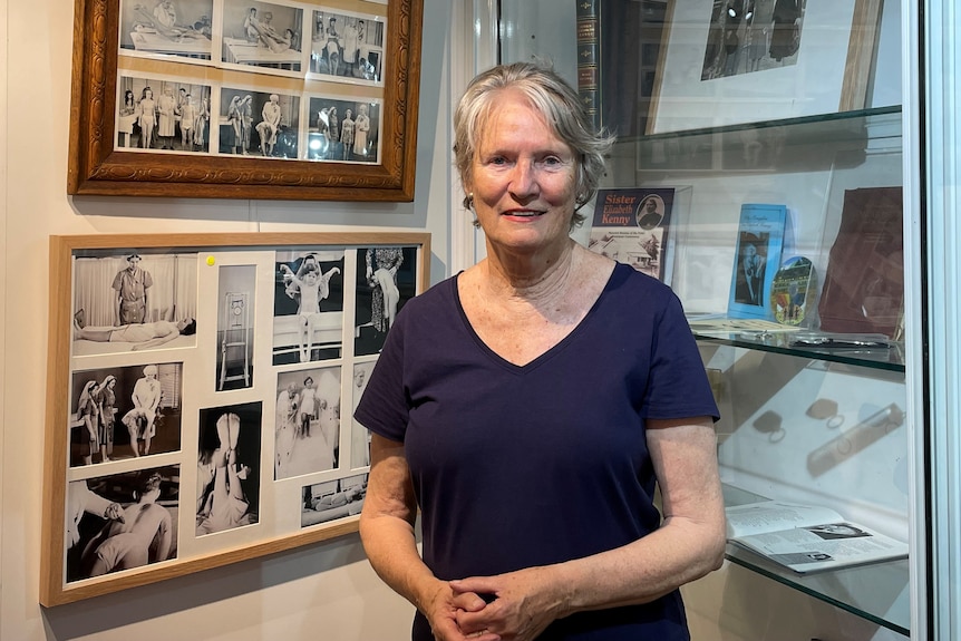 Woman looking at the camera with a series of polio photos behind her