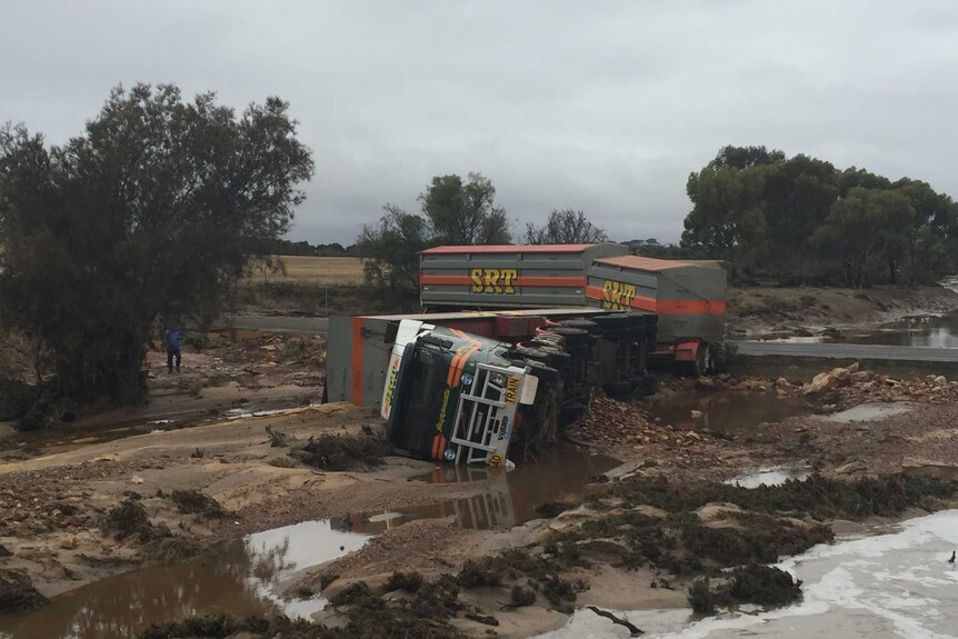 Overturned grain truck in flood water