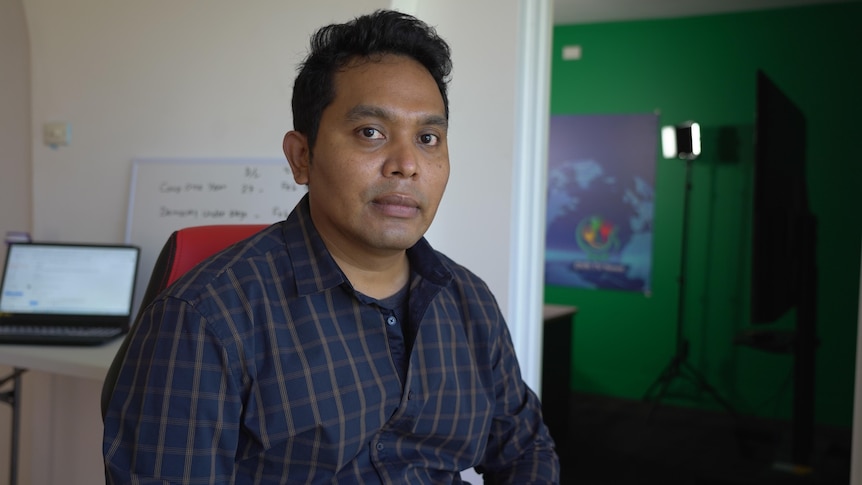 A Burmese journalist staring at the camera