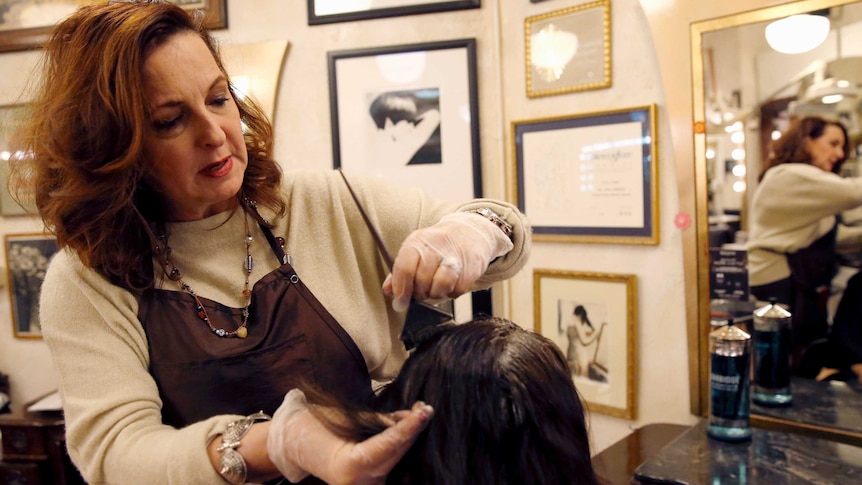 Karen Gordon, left, works on the hair of a client at J. Gordon Designs in Chicago, December 2016.