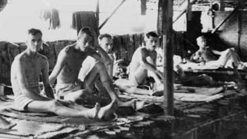 Prisoners of war inside a primitive hospital hut in Thailand during world war two