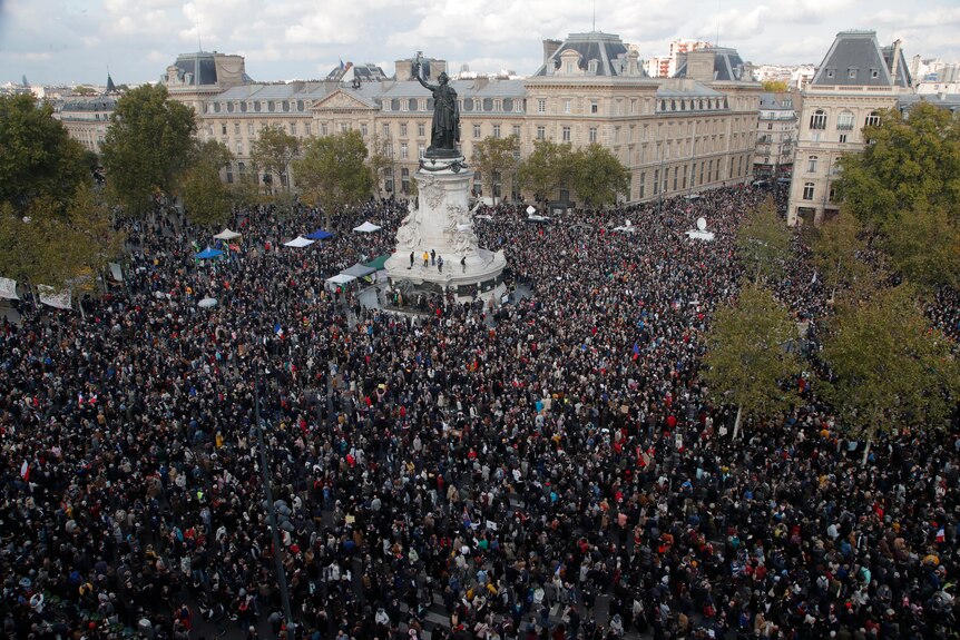 Thousands of people gathered at the Republique sqare in Paris where a large statue can be seen in the middle