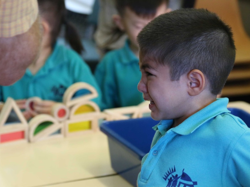 A young boy cries during his first day of kindergarten at Palmerston District Primary School in Canberra.