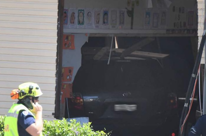 A car in the side of a building.