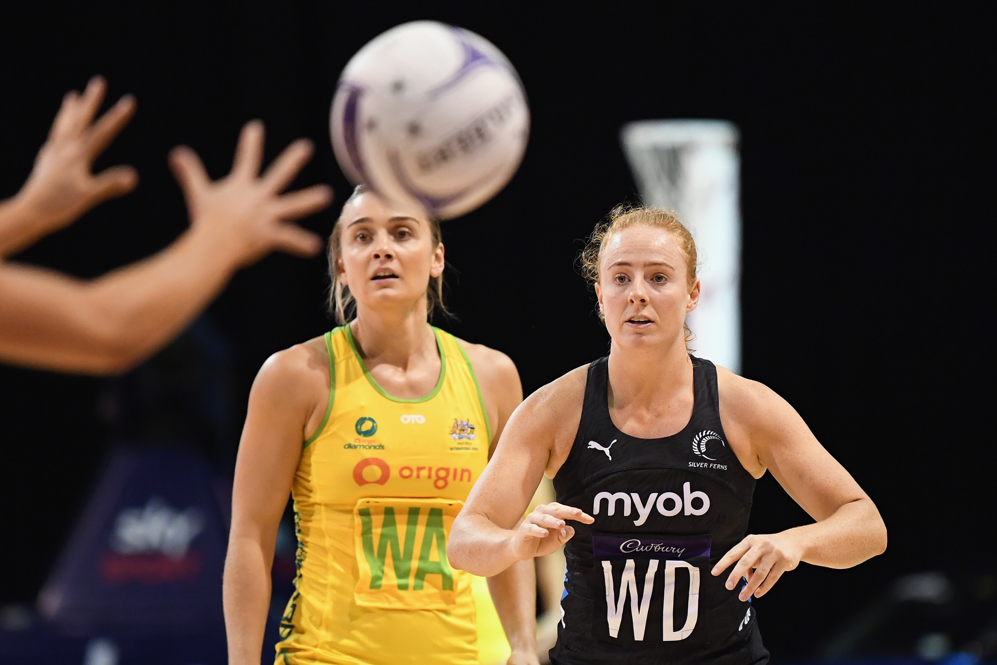 Sam Winders passes the ball to a teammate as she stands beside Diamonds captain Liz Watson