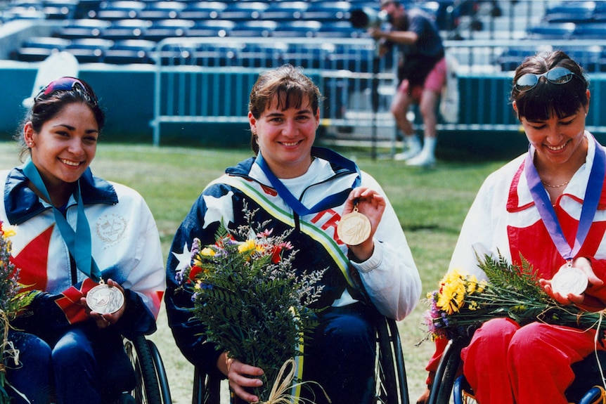 Australian wheelchair racer Louise Sauvage (C) with her gold medal at the Atlanta Paralympics.